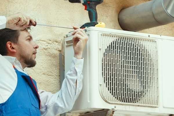 AC installation and repair expert technician in action