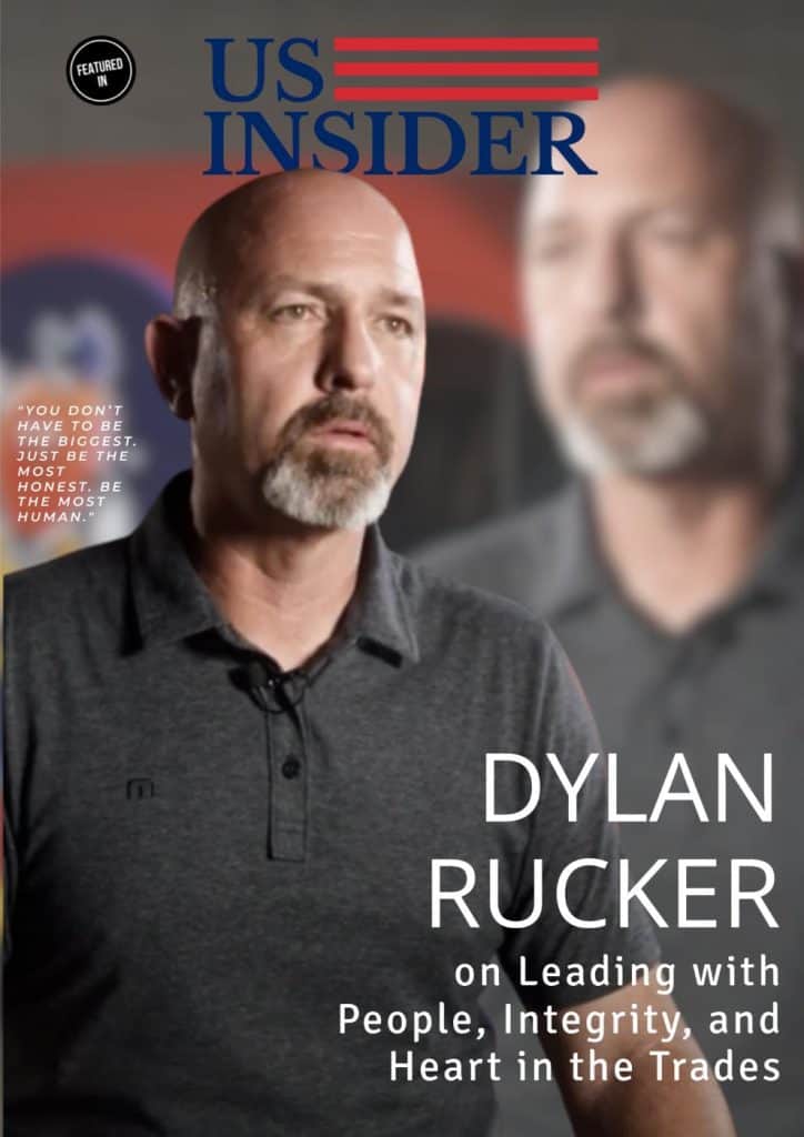 A man with a beard and shaved head wearing a gray polo shirt is featured on a magazine cover titled “US Insider” with the headline “Dylan Rucker on Leading with People, Integrity, and Heart in the Trades.”.